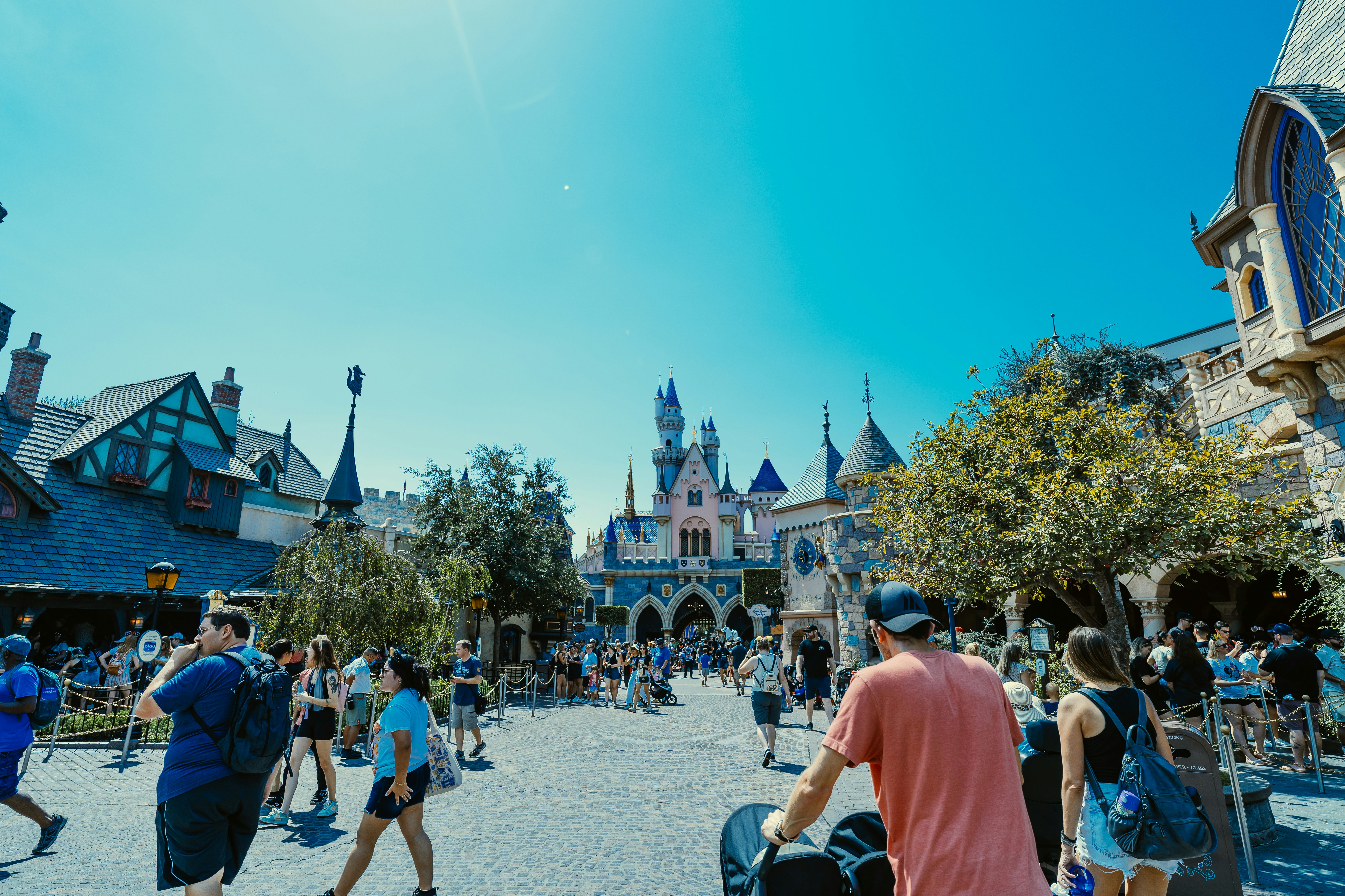 a group of people walking around a castle