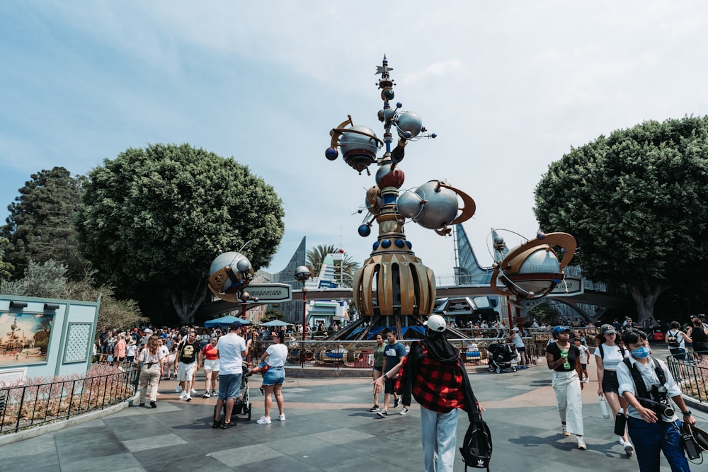 a crowd of people walking around a robot