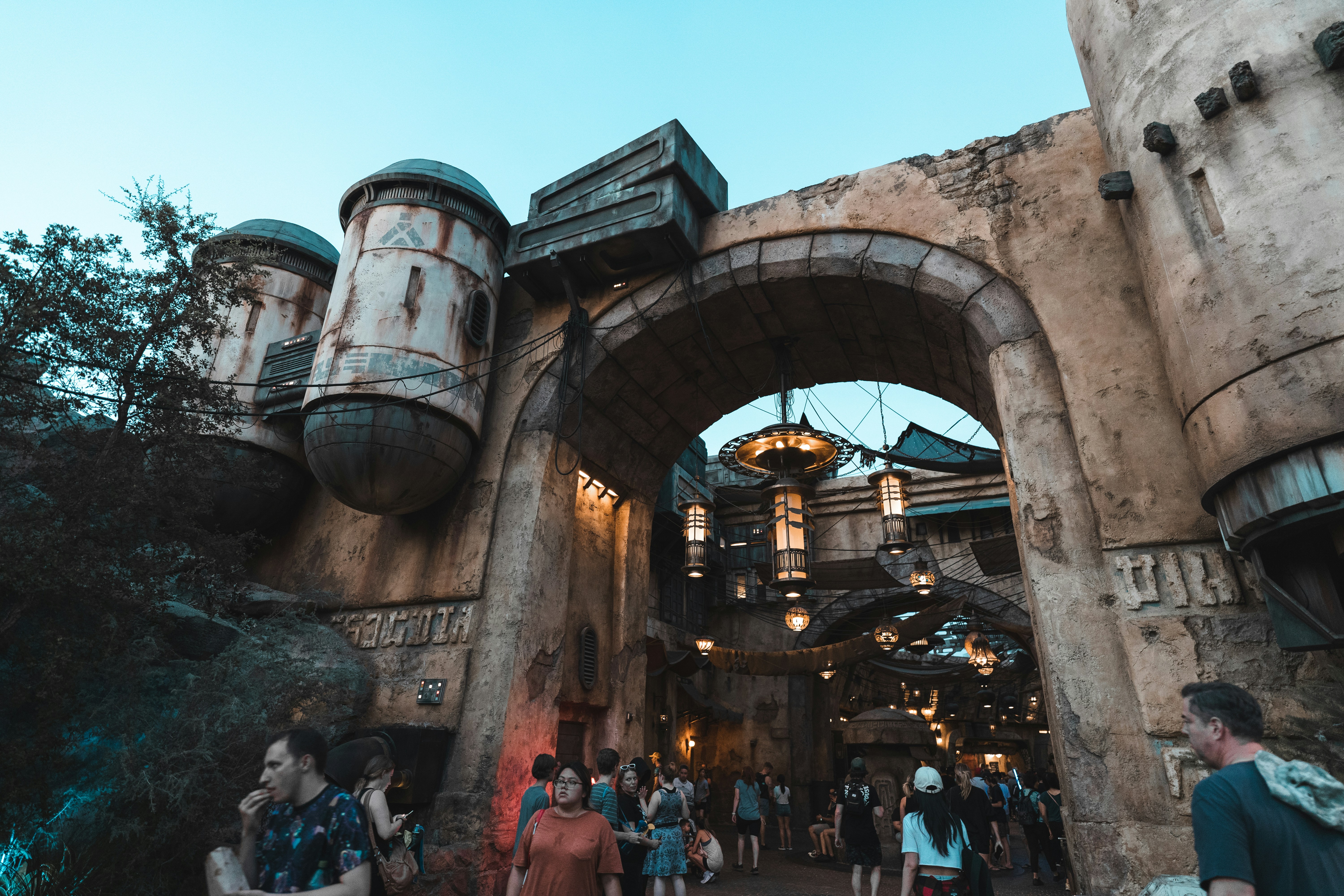 a group of people walking under a bridge