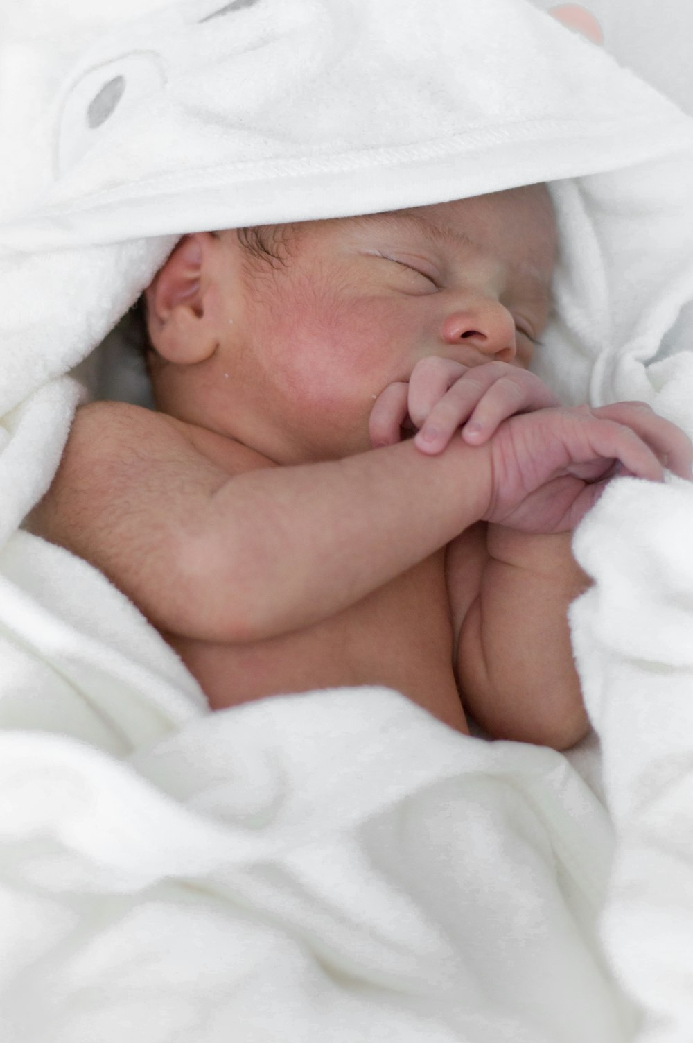 a baby sleeping in a blanket