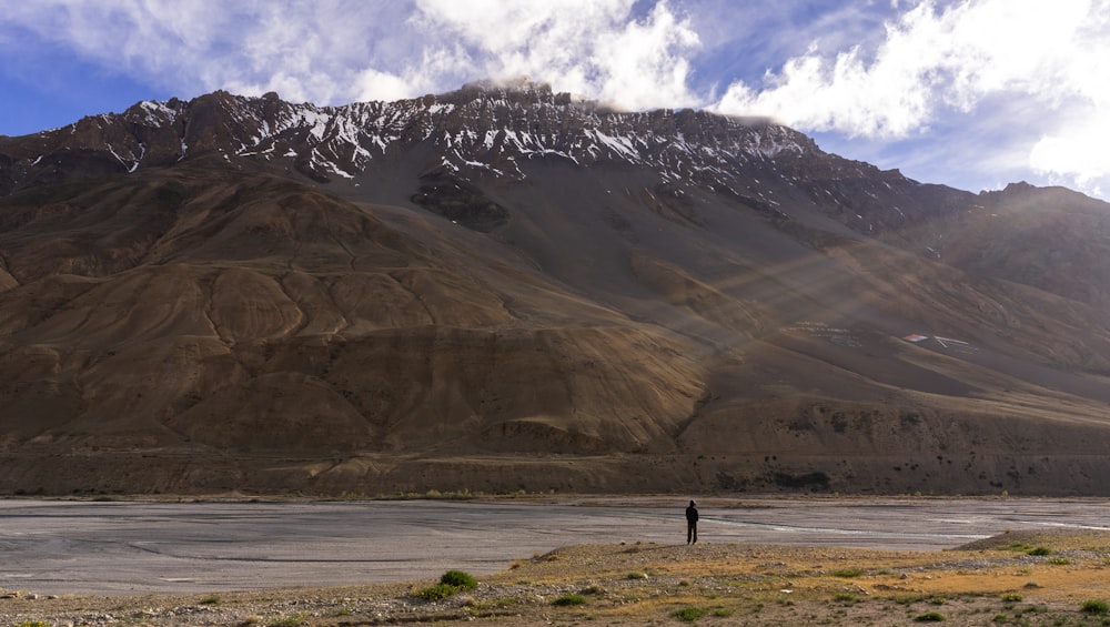 a person standing in front of a mountain