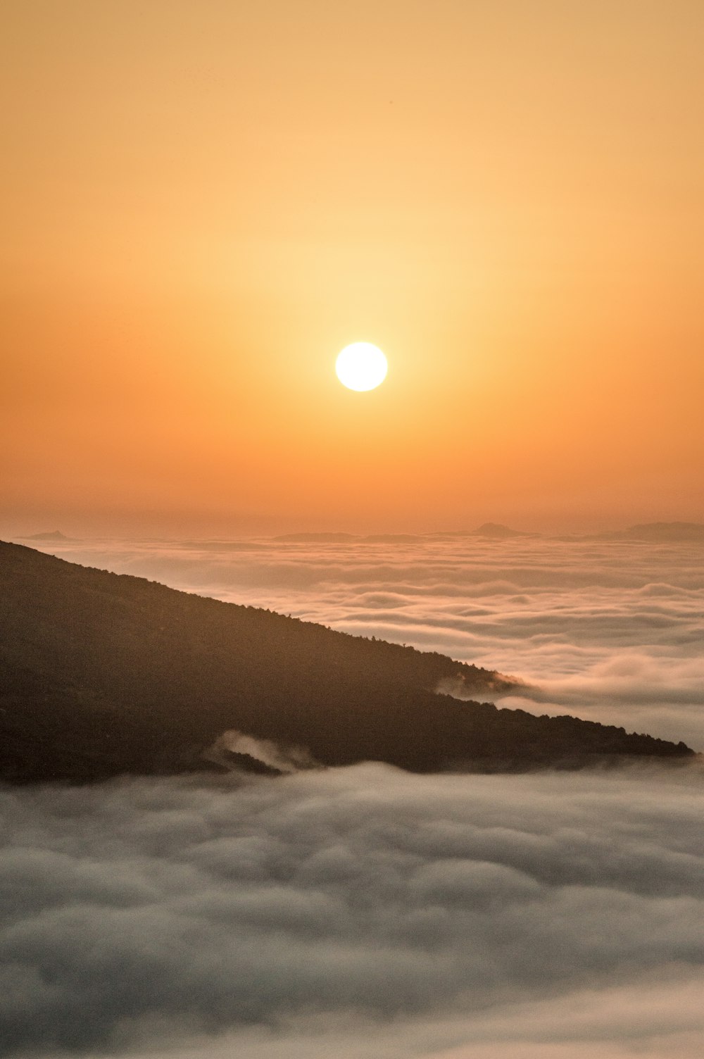 a sunset over a mountain