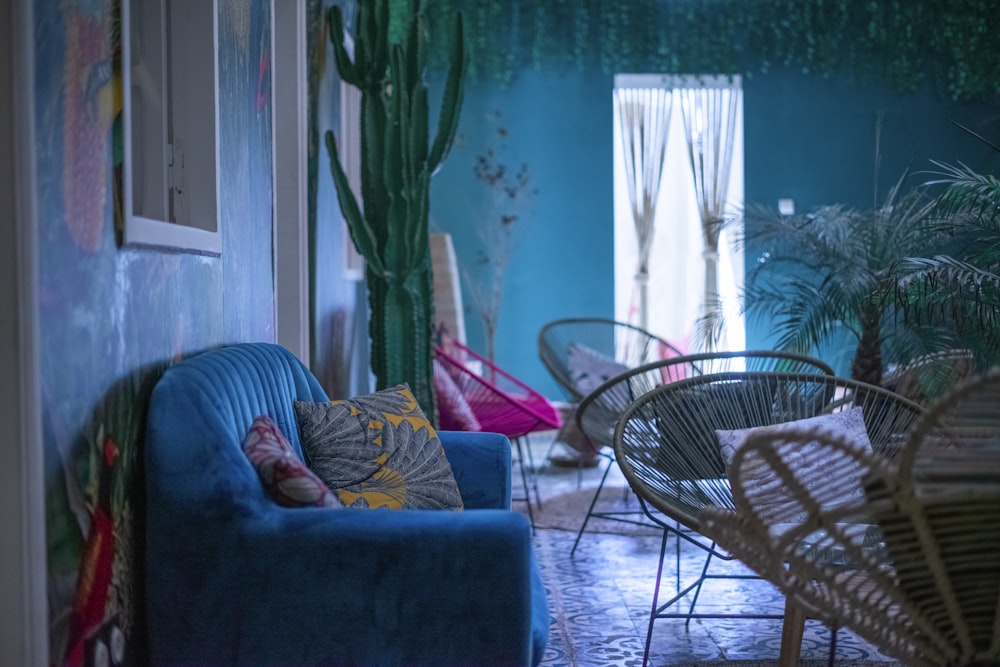 a living room with a blue couch and a chair