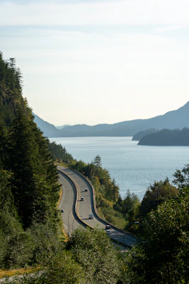 a highway with cars on it next to a body of water