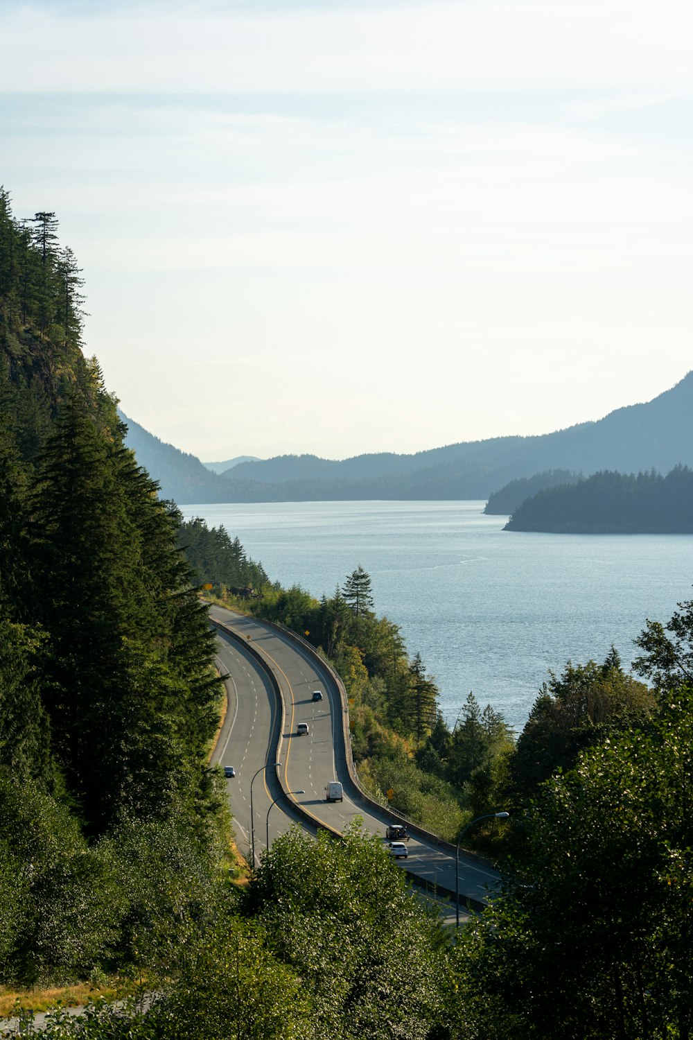 a highway with cars on it next to a body of water
