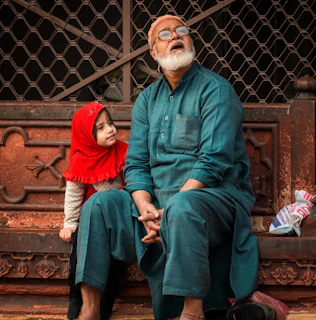 a man and a child sitting on a bench