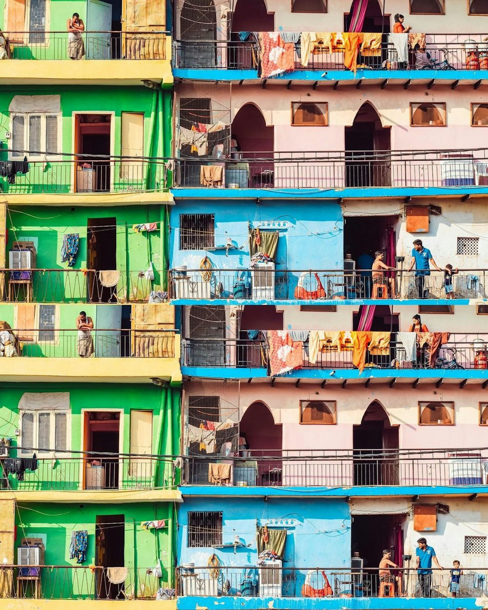 a group of people standing on a balcony of a building