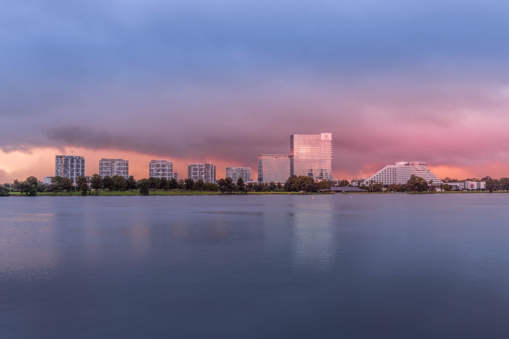 a body of water with buildings in the background