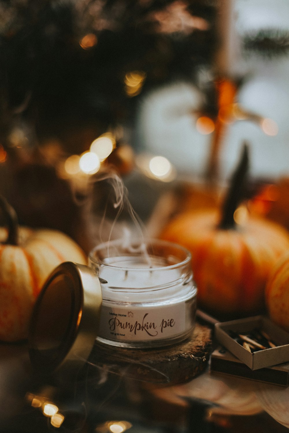 a glass jar with a liquid in it next to a glass jar with a candle in it