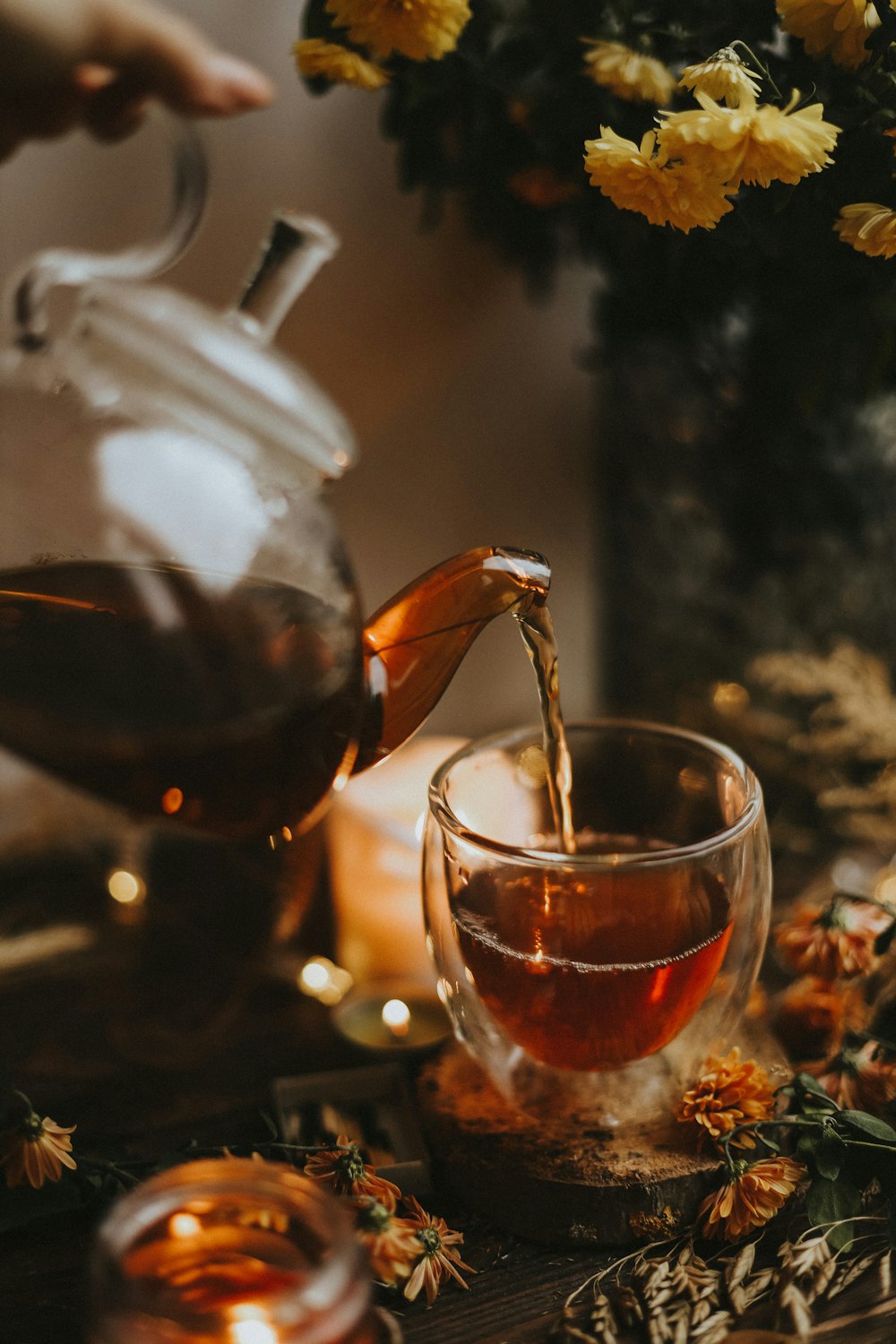 a tea kettle and a glass of tea on a table