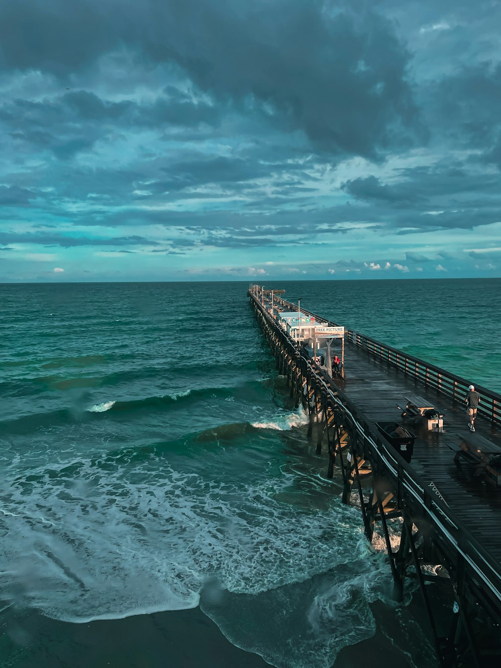 a pier with waves crashing against it