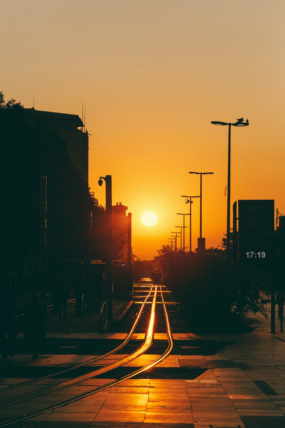 a street with buildings and a sunset