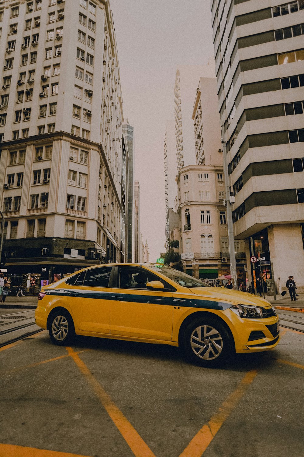 a yellow car parked in a city