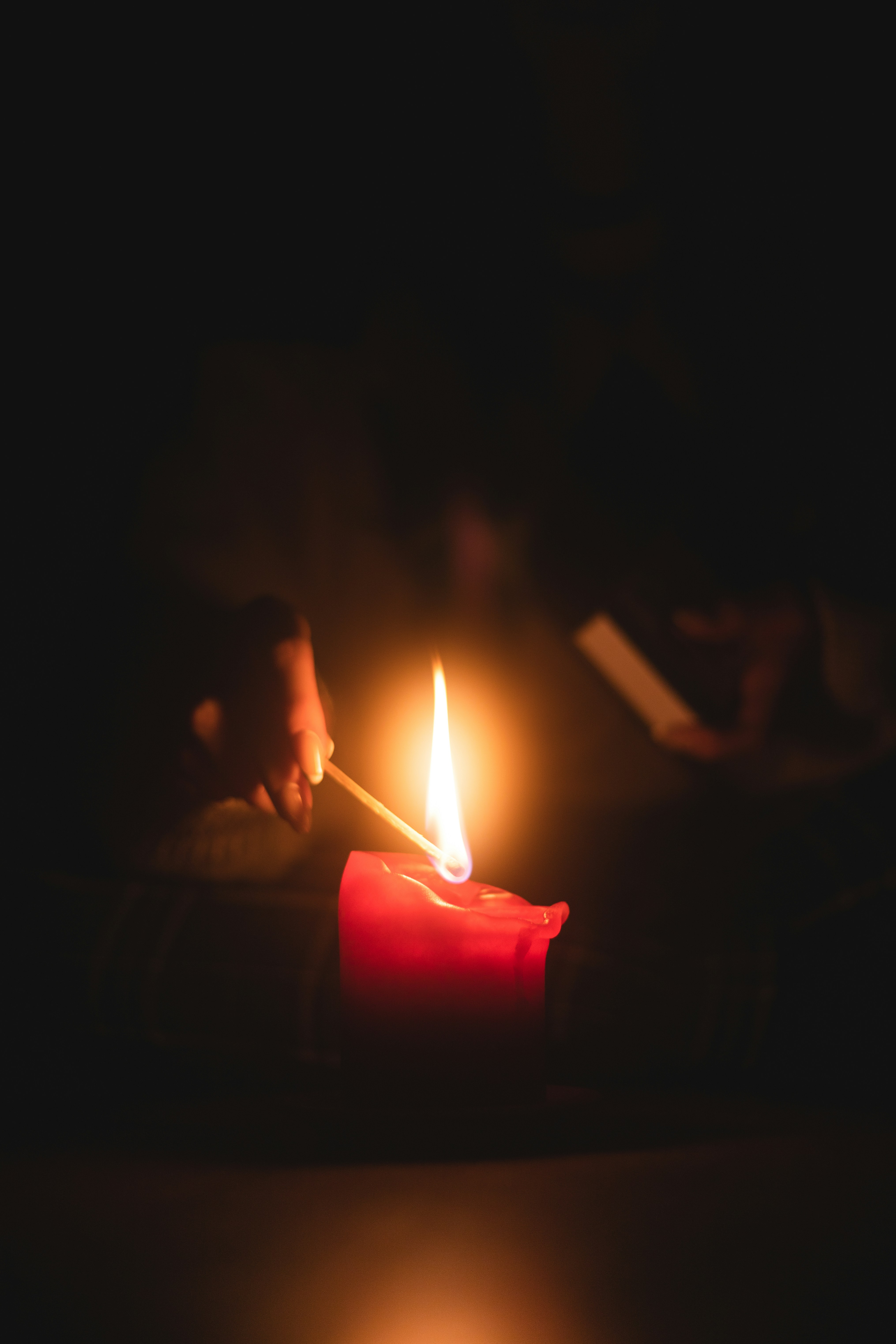 a person holding a lit candle