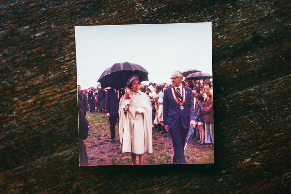 a man and woman walking down a path with an umbrella