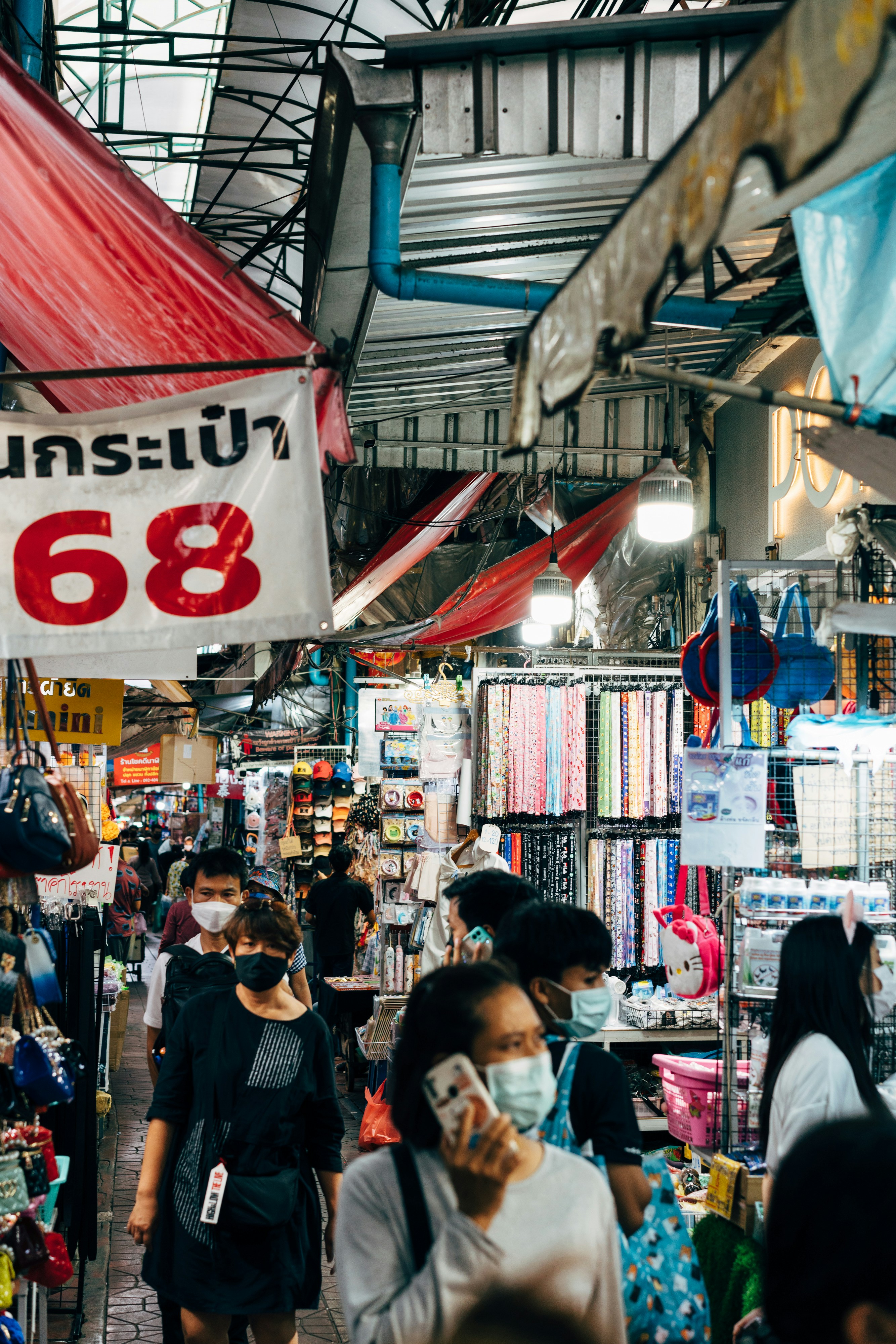 a group of people walk through a market
