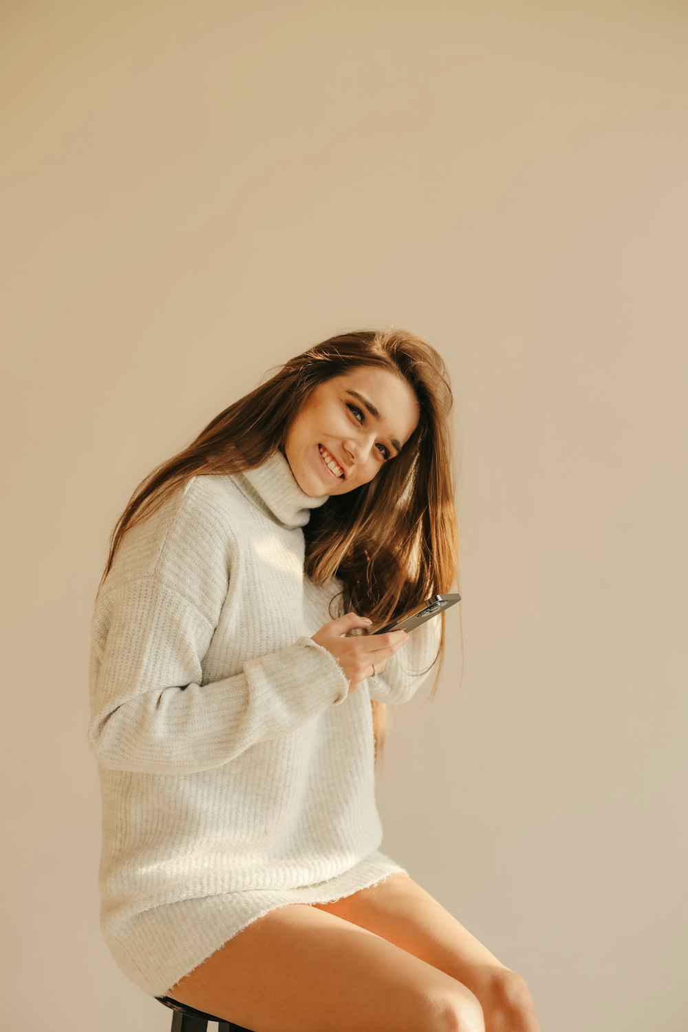 a woman holding a phone