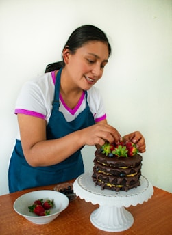 a woman cutting a cake