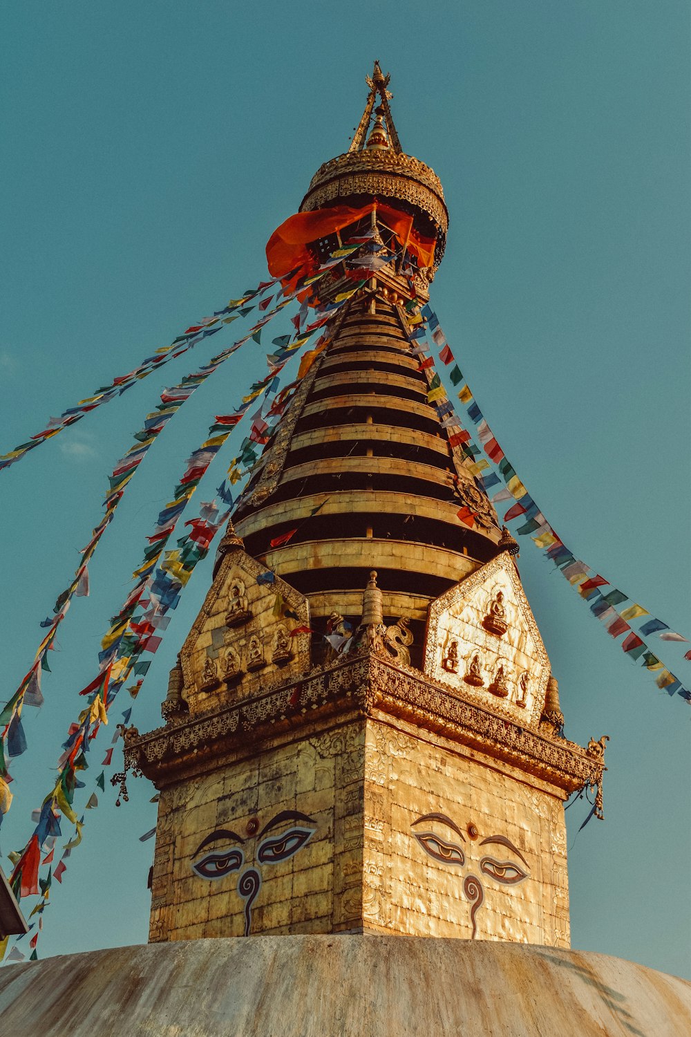 a tall building with a colorful roof with Swayambhunath in the background