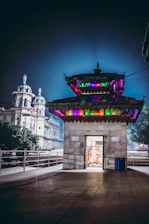 Evening shot of the partially built Yogeshwar Shri Krishna Mandir glowing softly under golden light.
