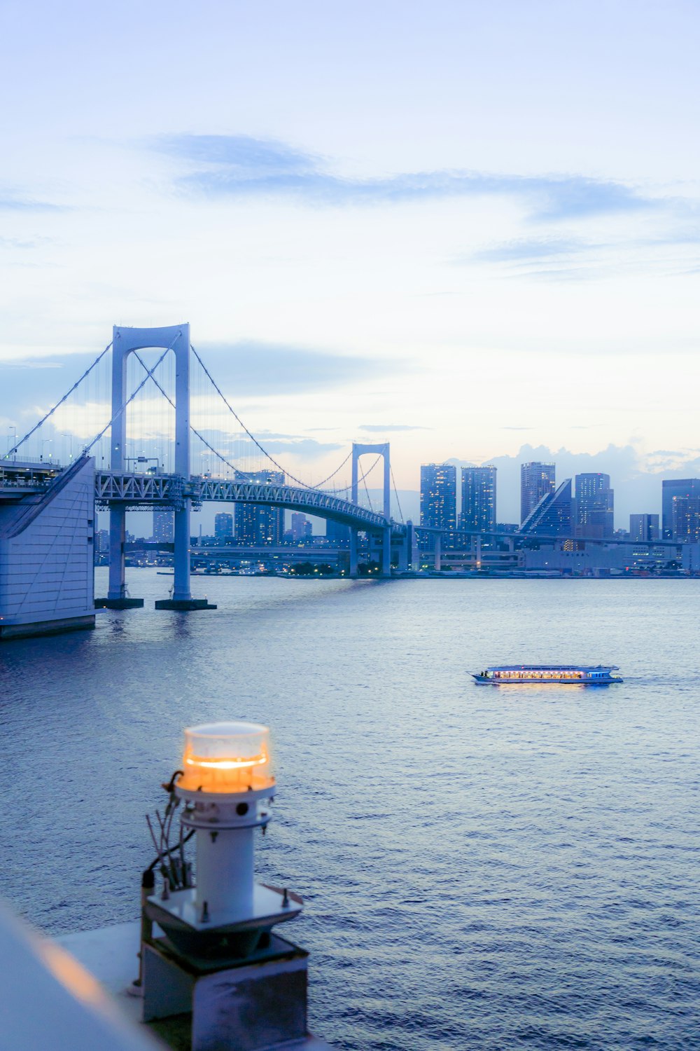 a boat in the water with a bridge in the background