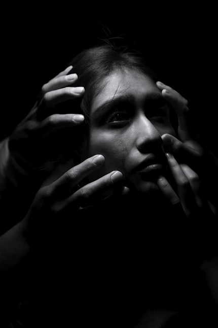 a man with his hands on his face