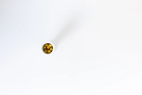 A sleek container of breed-specific supplements arranged on a clean white surface.