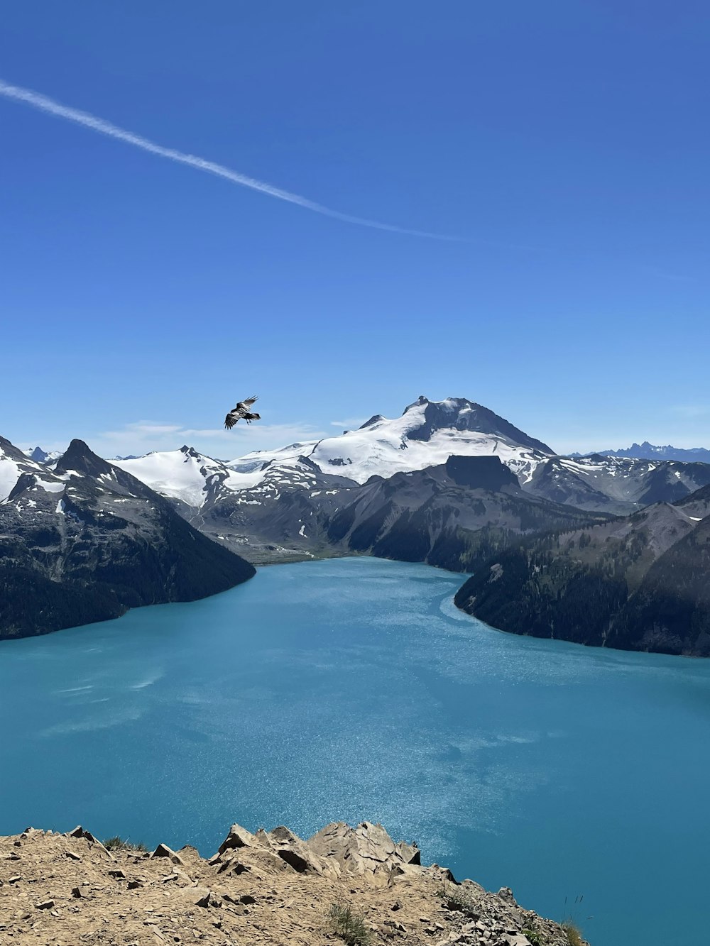 a body of water with mountains in the back