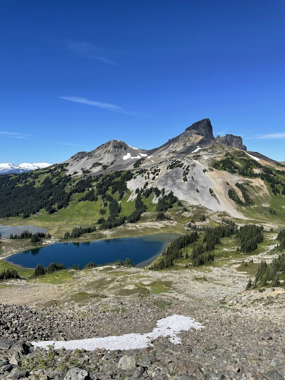 a lake in front of a mountain