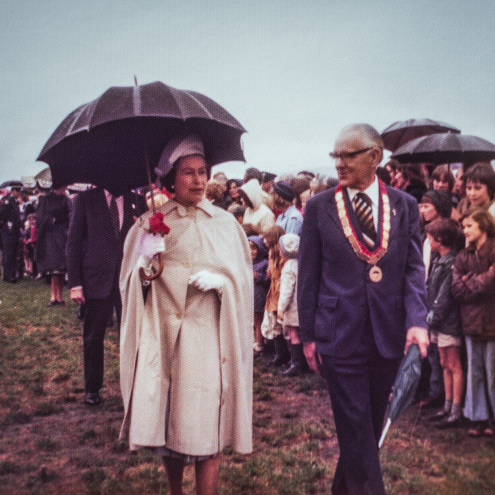 a man and woman walking with umbrellas