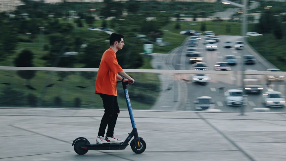 a boy riding a scooter