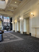 A stylish hallway featuring a levitex lift with subtle metallic accents and ambient lighting.