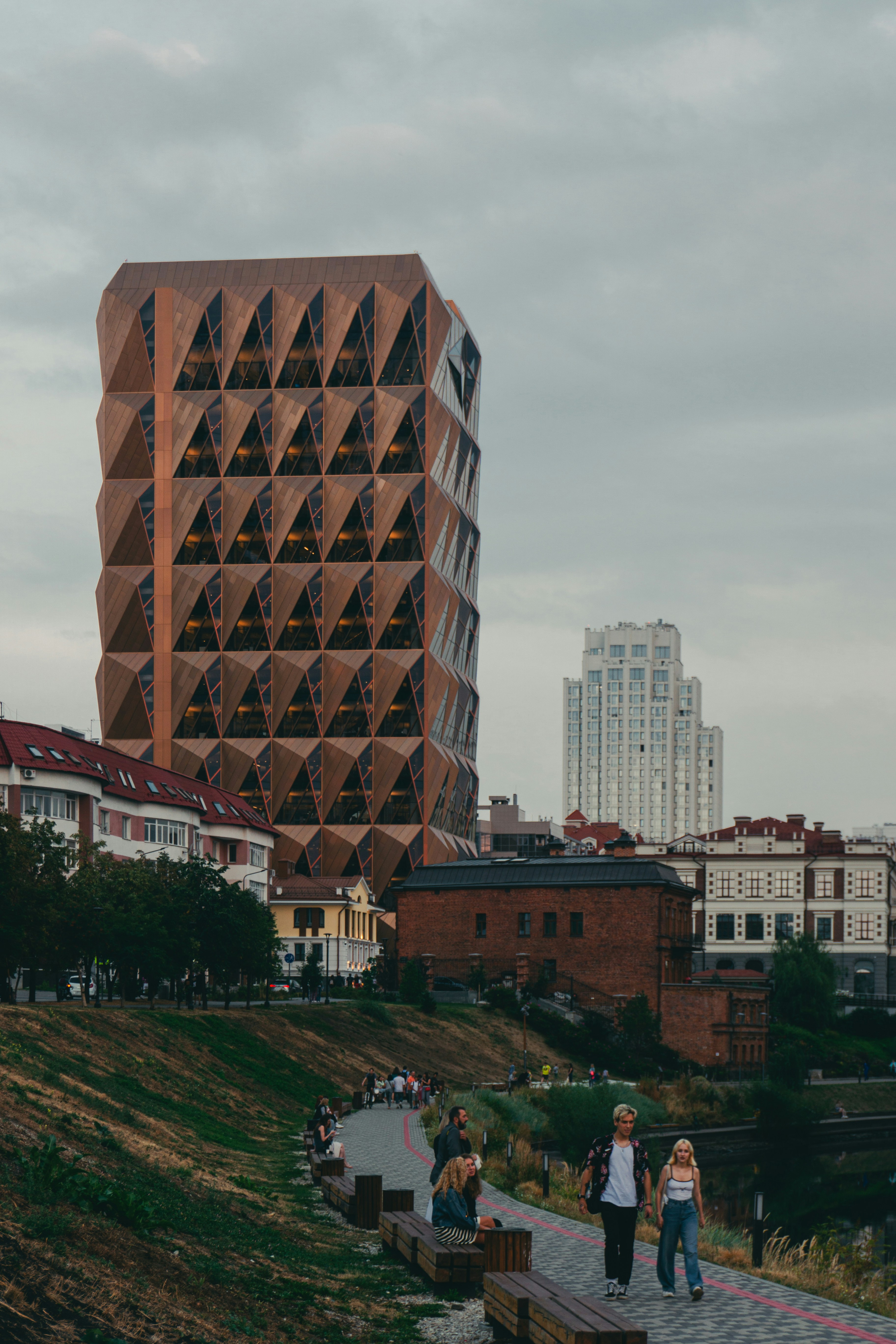 a tall building with a group of people standing in front of it
