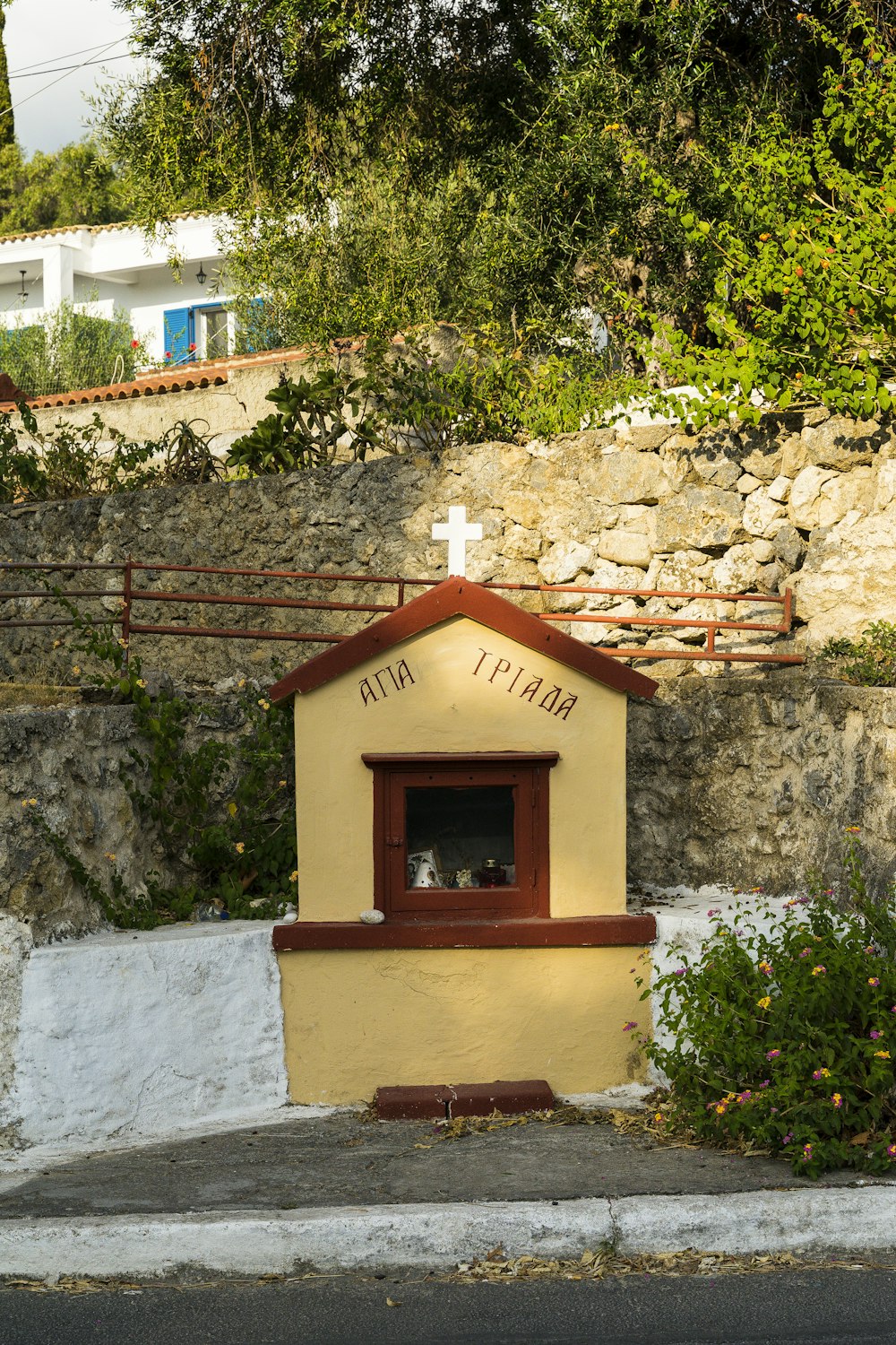 a stone building that has a sign on the side of a house