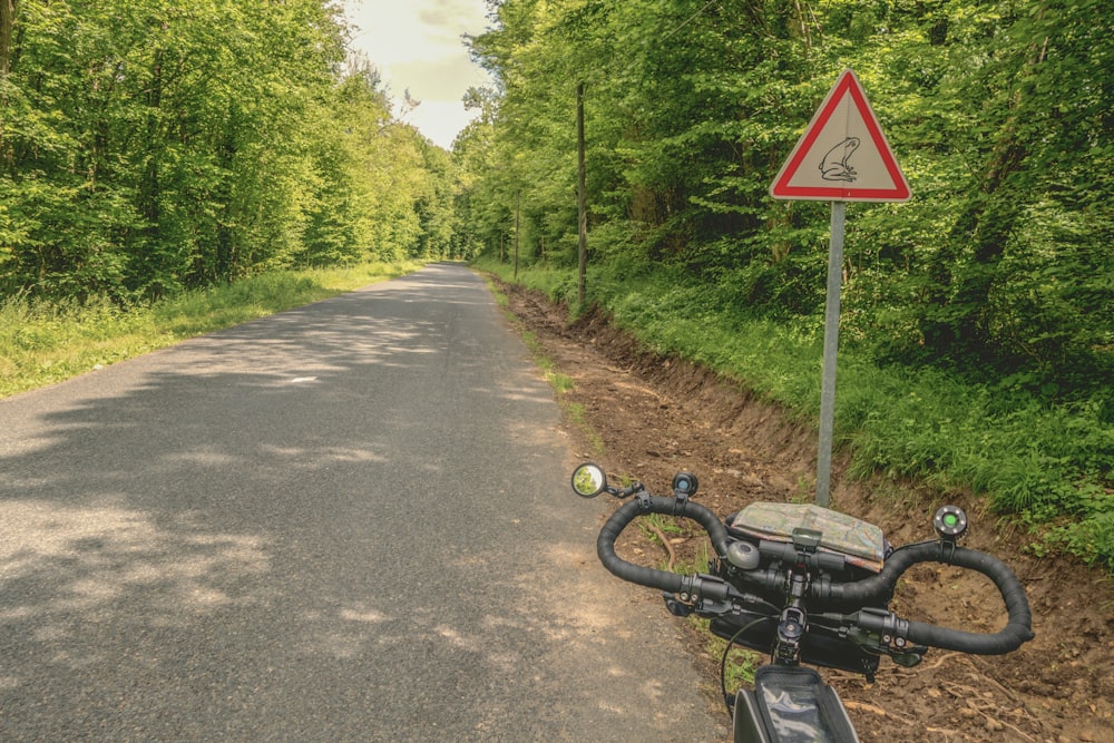 a bicycle parked on the side of a road