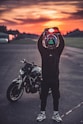 a person holding a motorcycle