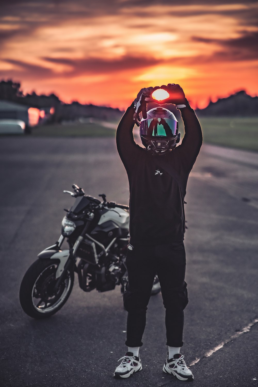 a person holding a motorcycle