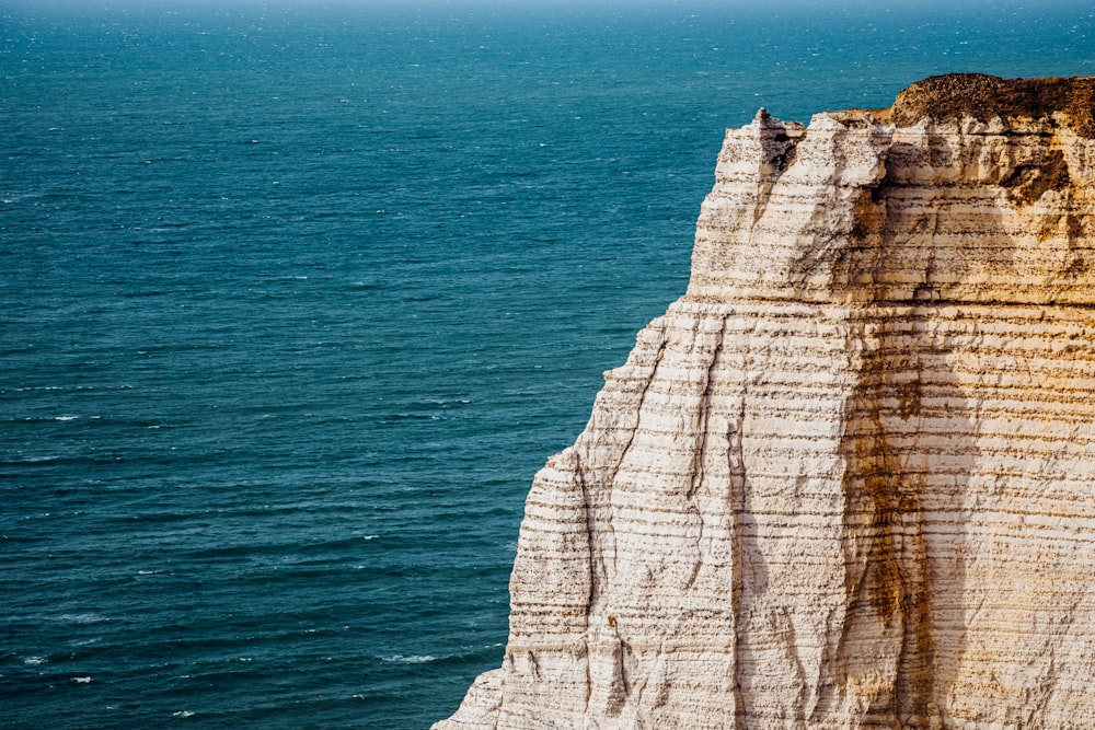 a cliff with a body of water below