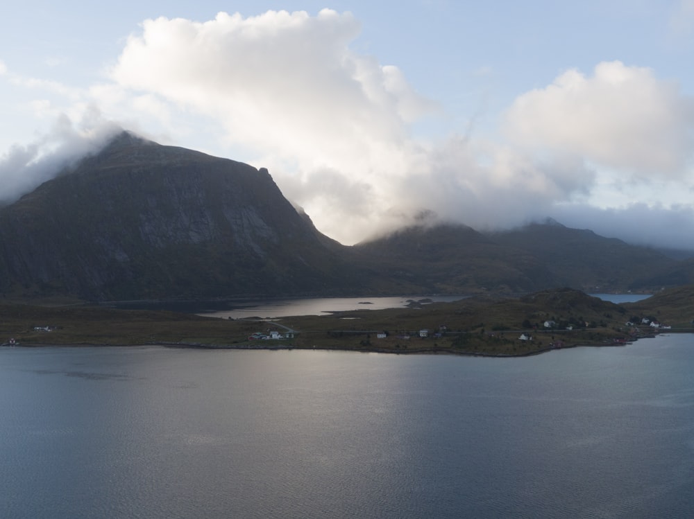 a body of water with mountains in the background