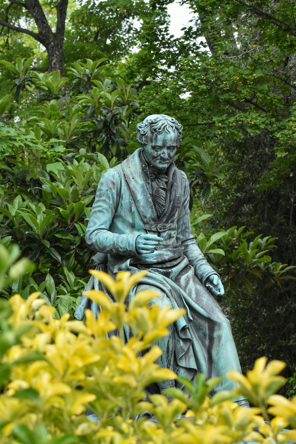 a statue of a man in a garden