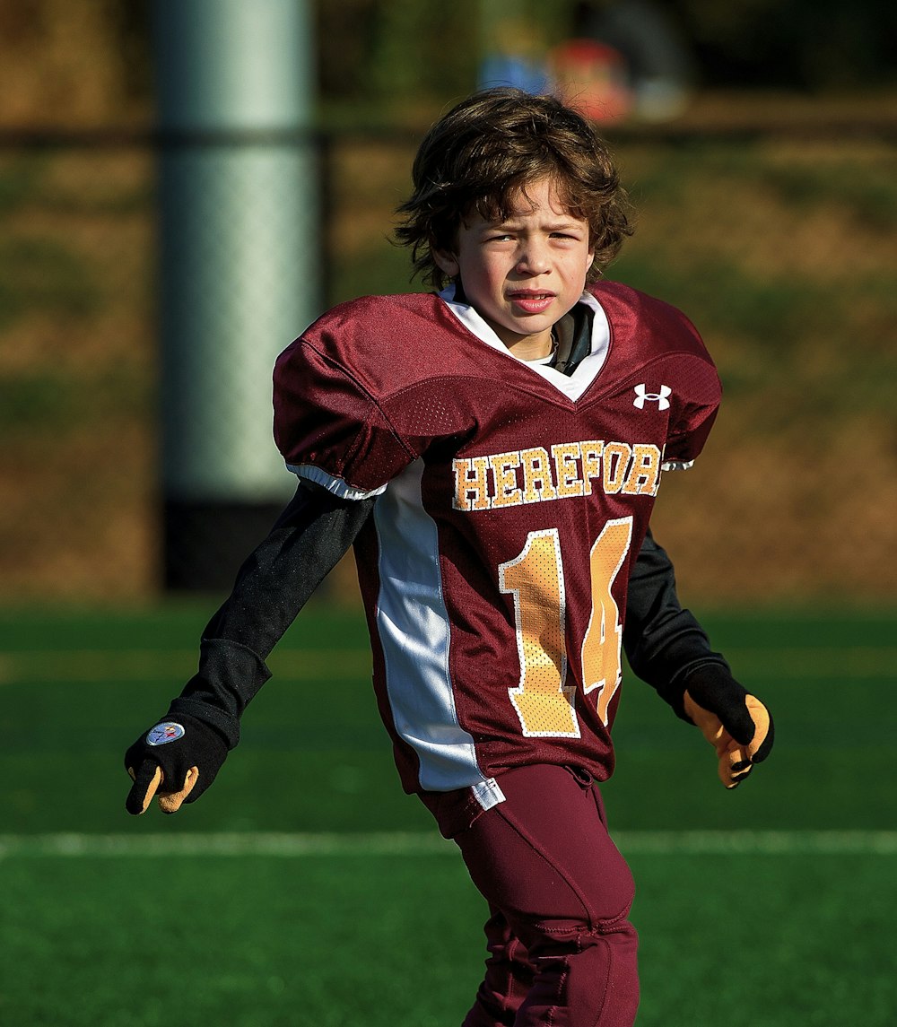 a boy running on a field