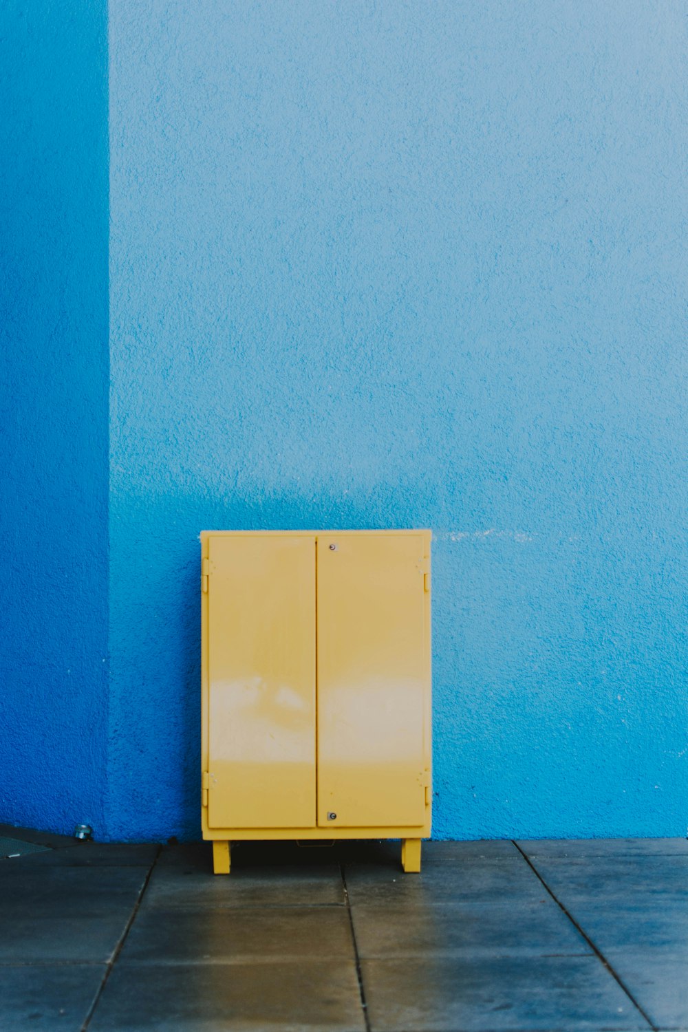 a yellow box on a blue wall