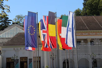 a row of flags in front of a building