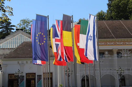 a row of flags in front of a building
