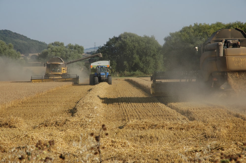 a few farm vehicles on a dirt road