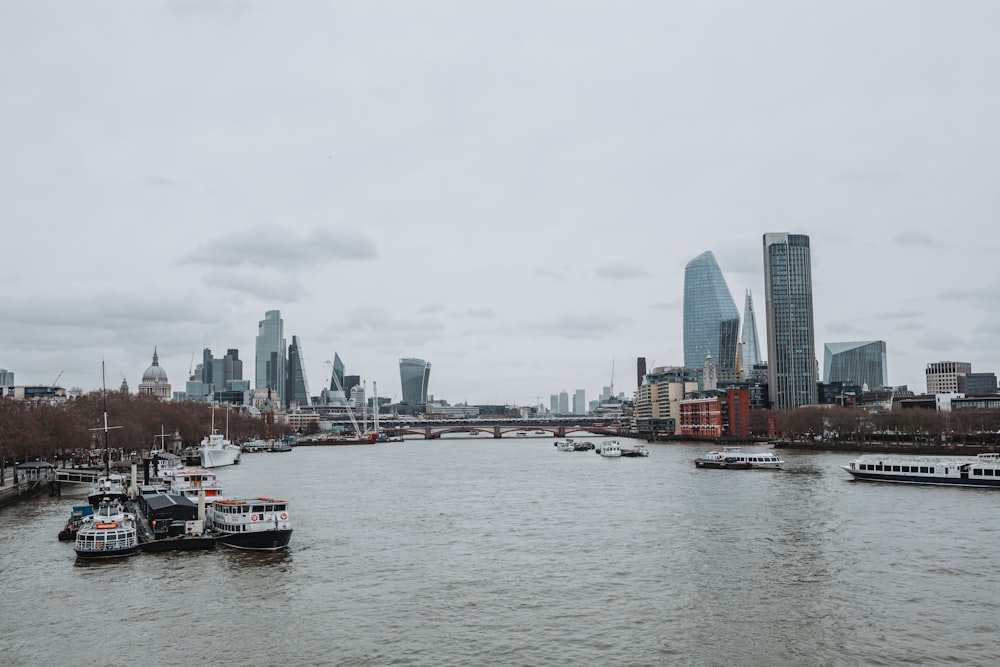 a body of water with boats in it and a city in the background