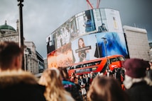 a large crowd of people in front of a large billboard