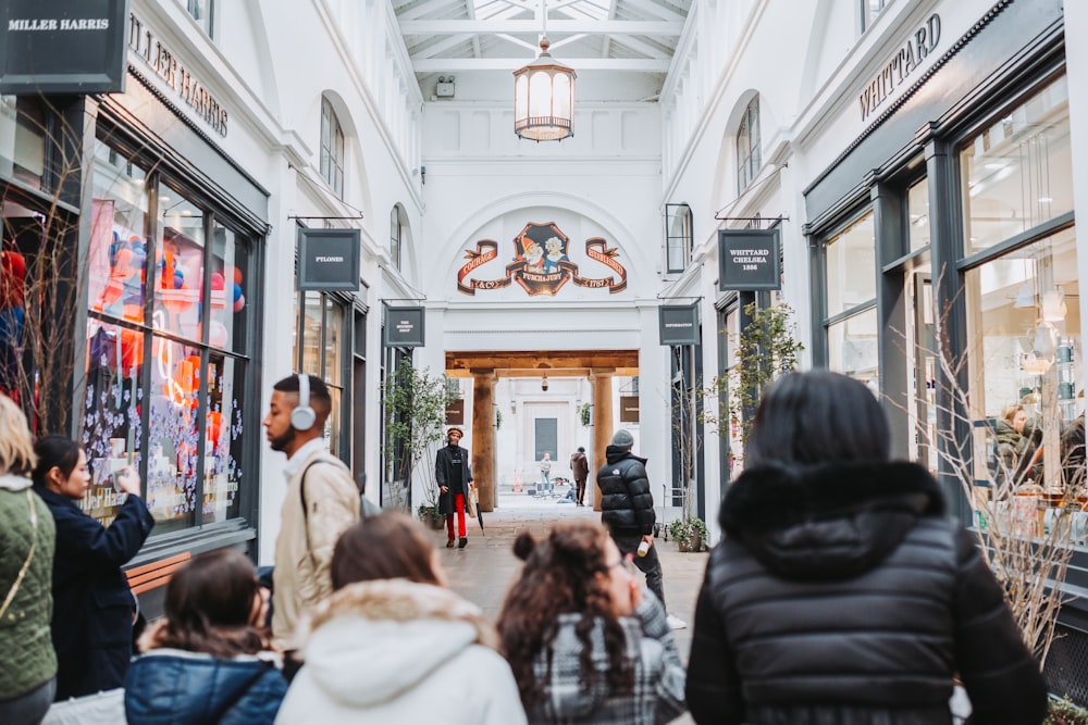 a group of people walking through a shopping mall