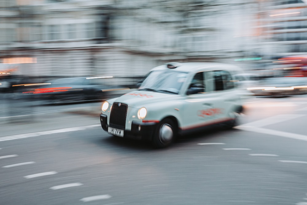 a white car driving on a road