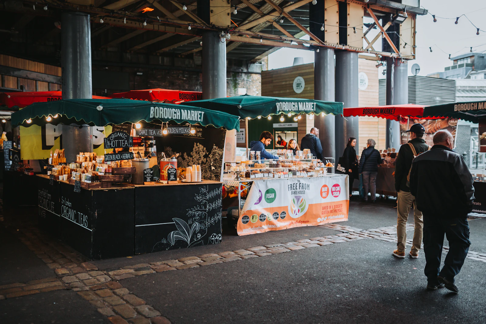 A group of people stand outside a food stand